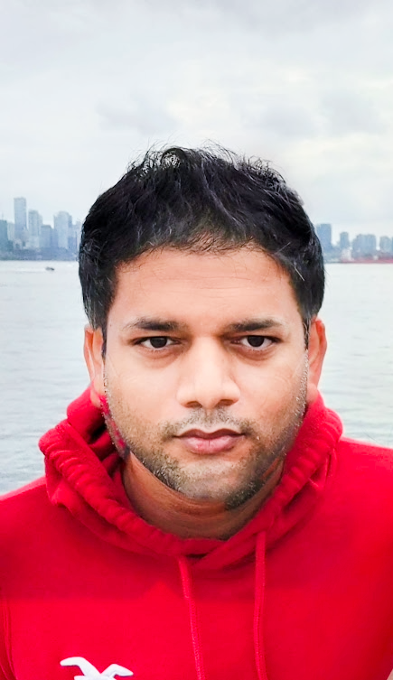 Pankaj Kumar in a red hoodie at a waterfront overlook